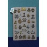 A collection of thirty British military cap badges including Irish examples and a County of London