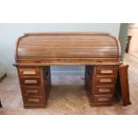 A substantial 1930's oak roll top desk with centre drawer (as found)