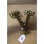 A pair of early 19th Century brass chimney cranes, each with adjustable hook and anchor motifs,