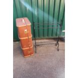 A vintage travelling trunk with metal black towel rail