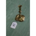 A fine early 18th Century seamed brass taperstick or small candlestick having knopped stem and