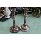 A pair of 19th Century silver plate on copper table candlesticks with foliate decoration,