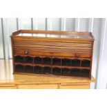 A late 19th Century mahogany roll front desk cupboard