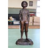 A 19th Century terracotta figure of a youth titled "Because it Pleases Me" (translated),