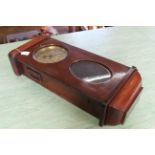 A vintage mahogany case hanging wall clock, chiming with brass face and key, no obvious makers mark,