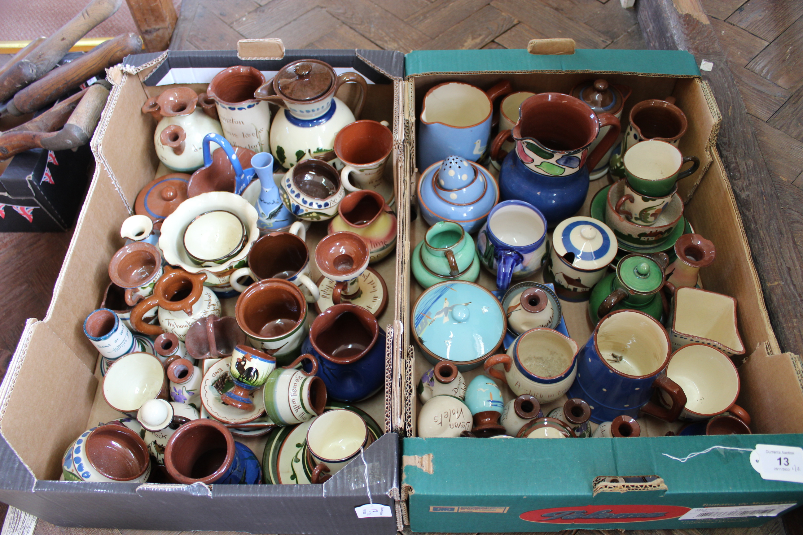 Two boxes with an extensive collection of Torquay and Devon motto ware (chips on some pieces)