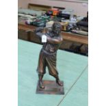 A bronze effect golfer fire companion set,
