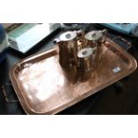 A rectangular two handled copper tray with engraved decoration and a set of three graduated hot