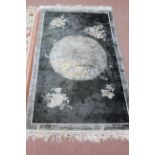 A small grey Chinese rug
