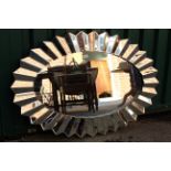 An unusual oval wall hanging mirror