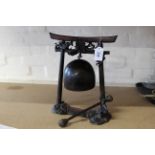 An early 20th Century Chinese patinated metal table gong and striker