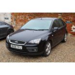 A black Ford Focus Zetec Climate, five door hatchback, registration number DK08 YVJ, approx.