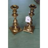 A pair of heavy 18th Century Spanish brass candlesticks with knopped stems and square bases with
