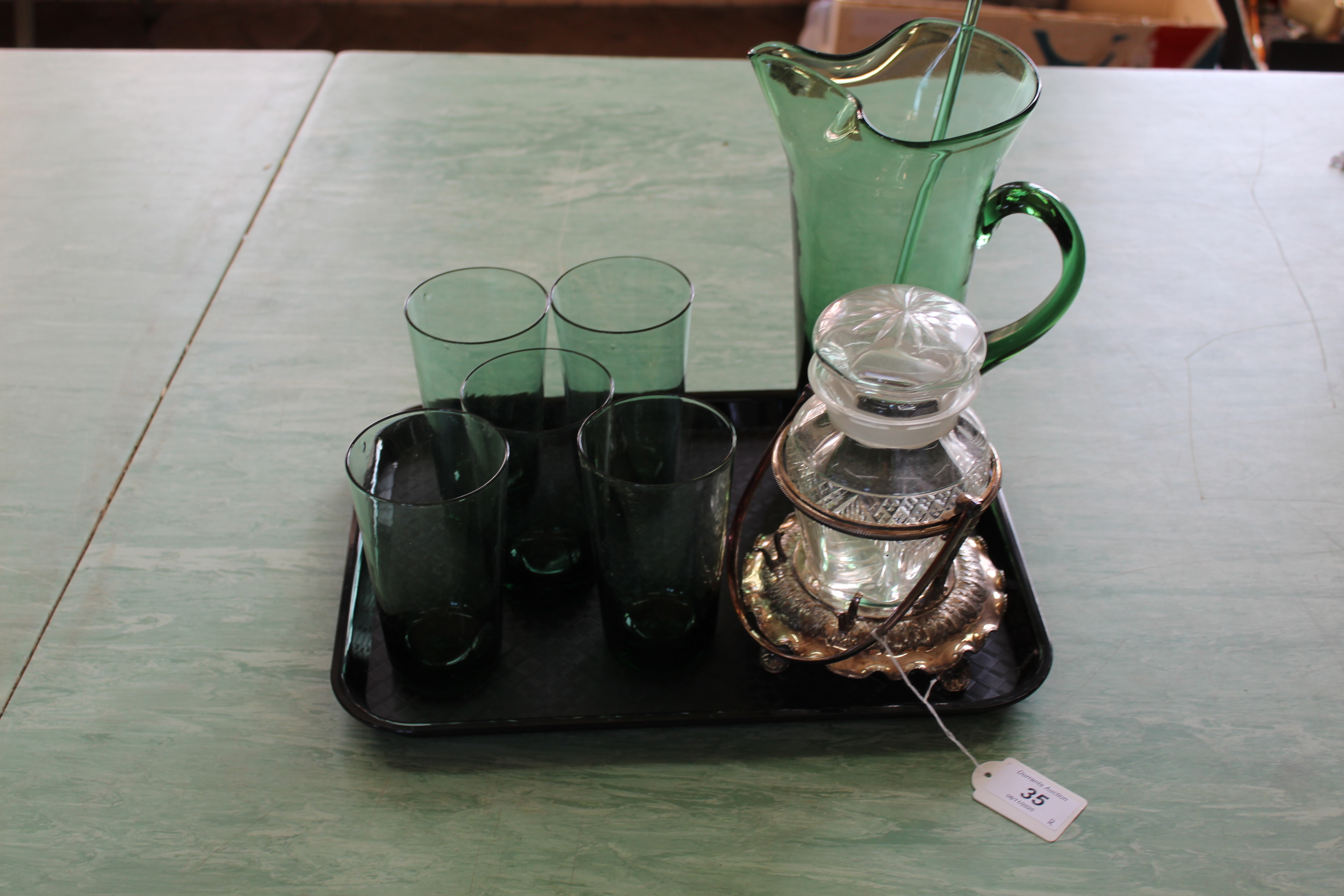 A green glass lemonade jug and five tumblers plus a cut glass pickle jar in a Walker and Hall