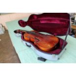 An early 20th Century cello in a travel case,