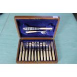 An oak cased canteen of twelve engraved silver plated and bone handled fish knives and forks with