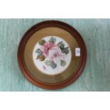 A 19th Century porcelain round plaque painted with flowers in a gilt frame