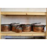 A matched set of five heavy 19th Century seamed copper saucepans and lids, all with iron handle,