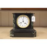 An early 20th Century black slate cased chiming mantel clock, no obvious maker's mark, lacking key,
