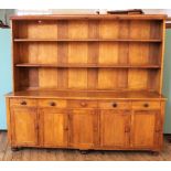 A 19th Century style oak kitchen dresser comprising a shelved top with five drawers and five