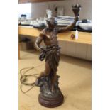 A large bronzed spelter figure table lamp on red stone base,
