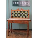 An Edwardian satinwood marble top washstand, with single drawer and tiled upstand,
