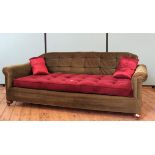A vintage low day bed style settee, on oak bun feet with castors,