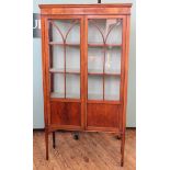 An Edwardian mahogany two door display cabinet with two shelf interior, width 35" x depth 13",