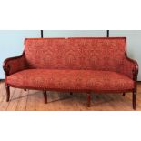 A William IV mahogany upholstered settee, scroll arms and sabre front legs,