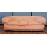 A Victorian Chesterfield sofa upholstered with checkered cream fabric,