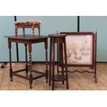 An Edwardian mahogany fire screen, a plant stand,