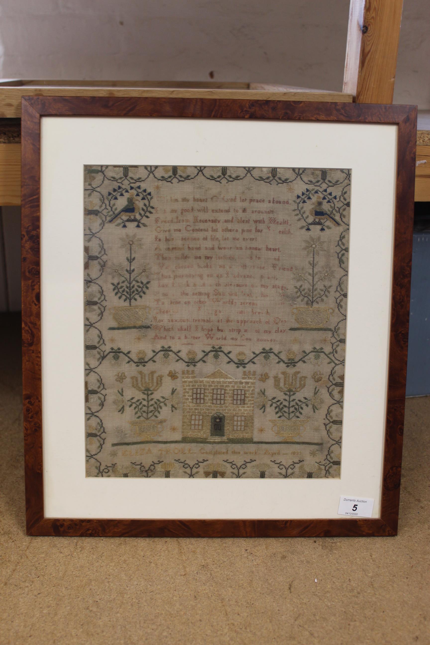 A framed sampler with verse within and decorative border with house by Eliza Troll,