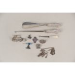 Mixed silver items including an enamelled Royal Artilleries badge, coin bracelet, badges,