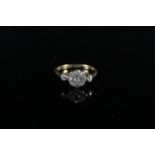 An 18ct platinum set diamond cluster ring of floral form with diamond set shoulders,