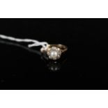 An 18ct gold pearl and diamond ring, the single pearl centre with eight old cut diamond border,