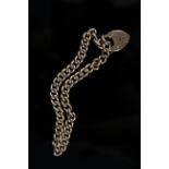 A 9ct gold curb link bracelet with heart shaped padlock clasp,