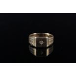 An 18ct gold gents signet ring set with a single diamond in star cut setting with engraved