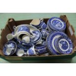 A box of assorted blue and white dinner and tea wares, mainly Willow pattern,