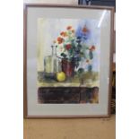 A large framed watercolour of a still life with pot plant, fruit and glass jug,