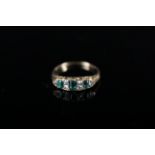 An 18ct gold emerald and diamond ring,