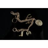 A 9ct gold charm bracelet (watch chain conversion) with several charms including a 9ct gold back