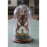 A Thwaites & Reed striking skeleton clock under glass dome,