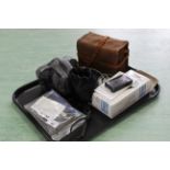 A Brownie box camera, an Olympus 35mm camera and spare 28mm lens,