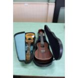 Two cased ukuleles,