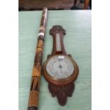 An Edwardian carved oak banjo barometer plus an African rain stick