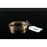 A 9ct gold foliate engraved bangle (heavily dented),