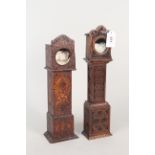 A carved oak pocket watch stand in the form of a long case clock,