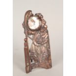 An unusual Chinese copper pocket watch stand decorated with a central figure in classic costume