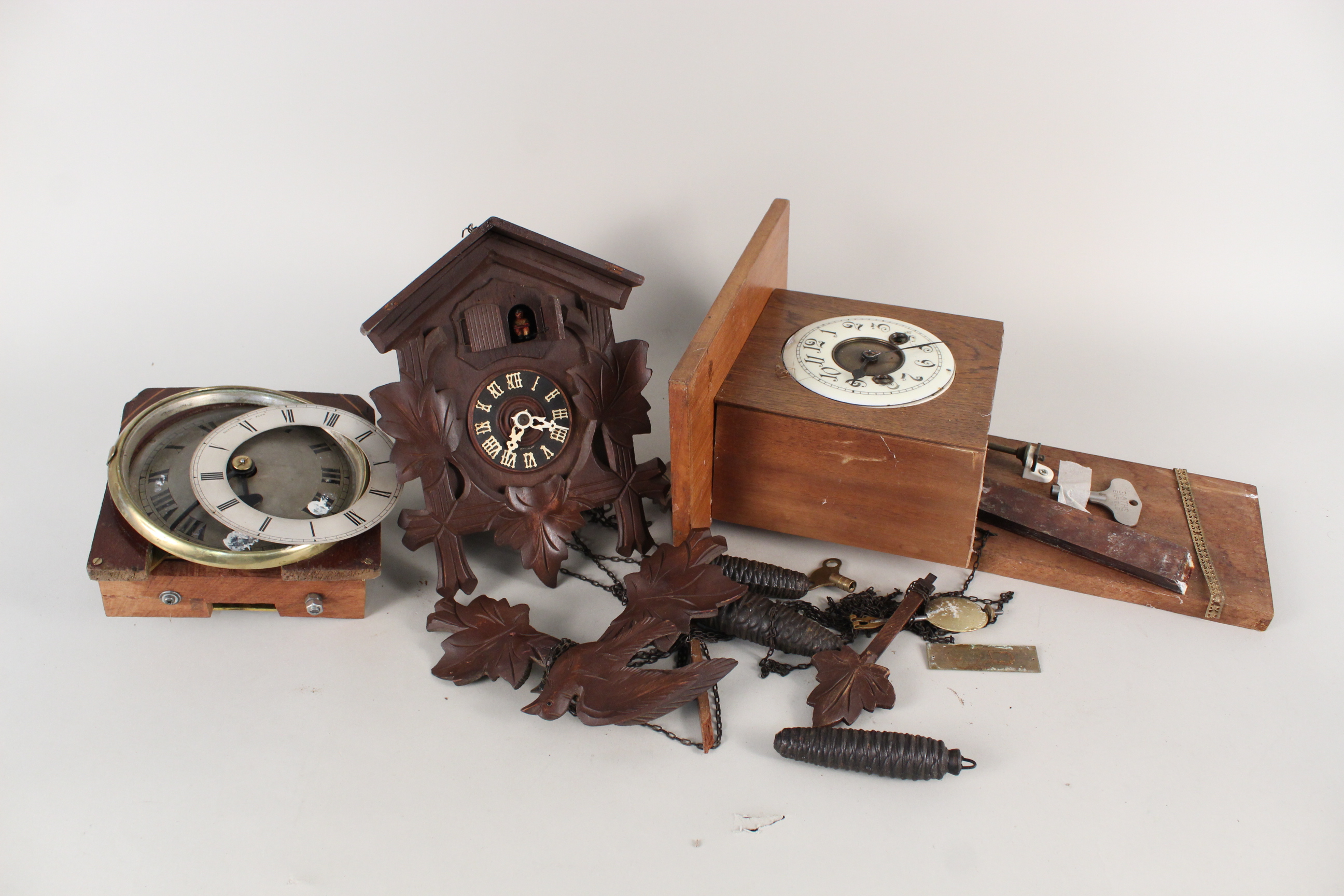 A German cuckoo clock plus two clock mounted movements (as found)