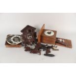 A German cuckoo clock plus two clock mounted movements (as found)